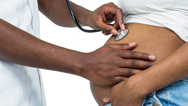 doctor examines belly