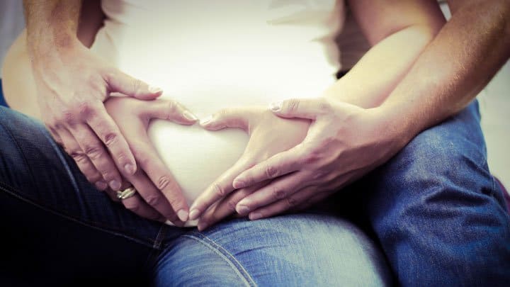 Man holding pregnant woman
