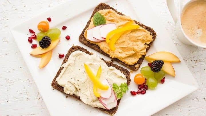 Rye bread and fruit on plate with coffee
