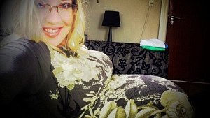 woman lying on coach being 29 weeks pregnant with twins